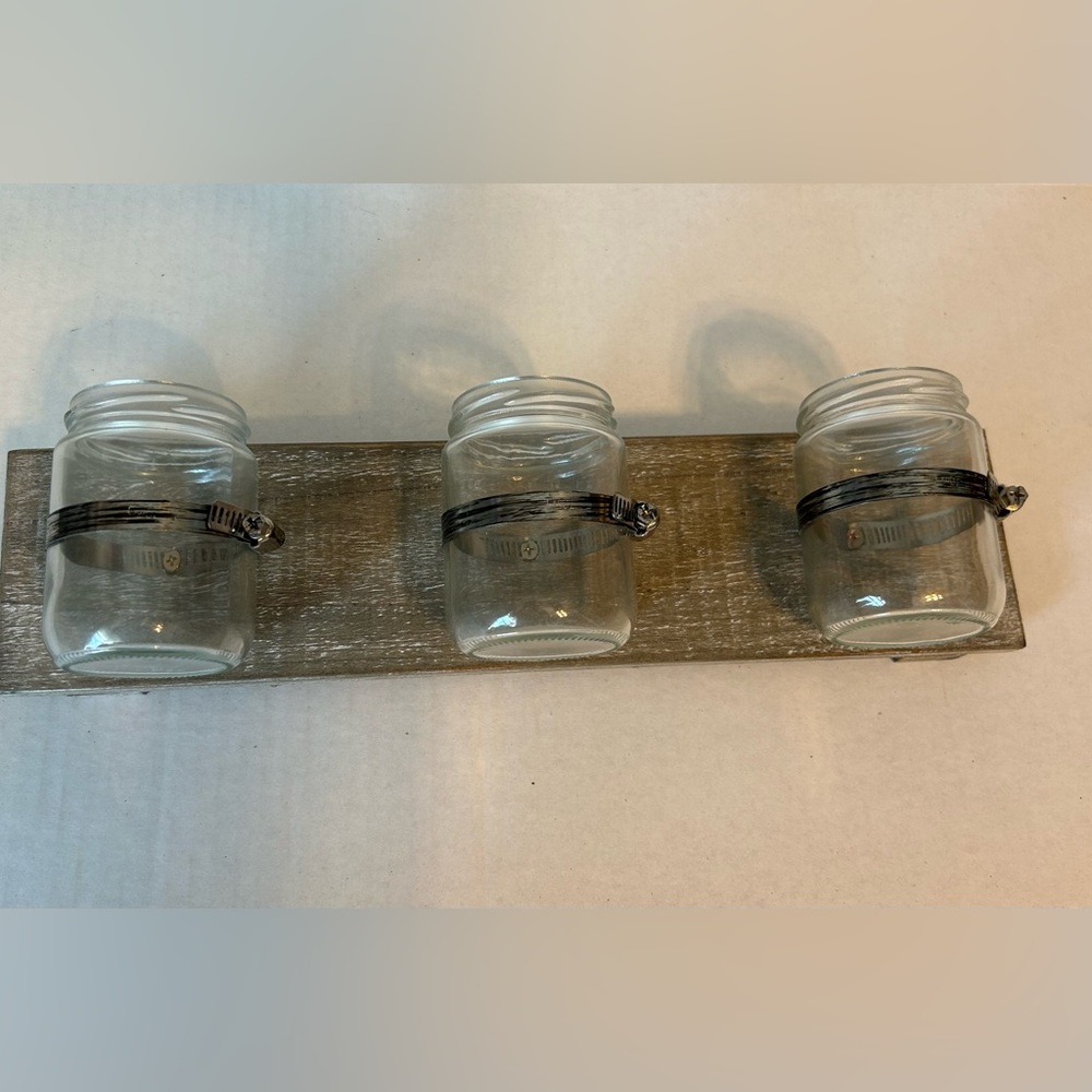 Rustic wood wall decor with 3 glass containers